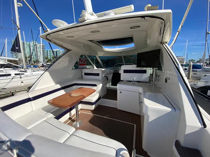Day Dreamer Yacht Photos Pics 2010 Sea Ray 450 Sundancer yacht interior with seating, table, and TV at marina.