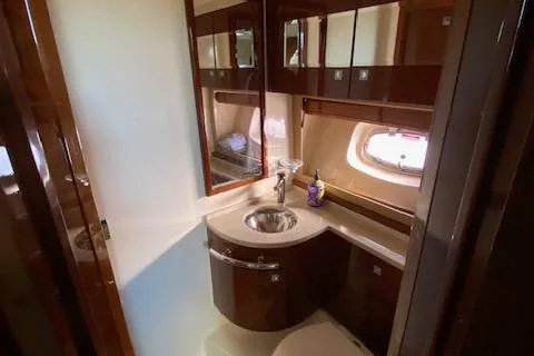 Day Dreamer Yacht Photos Pics Luxurious bathroom in 2010 Sea Ray 450 Sundancer yacht with modern fixtures and wood accents.