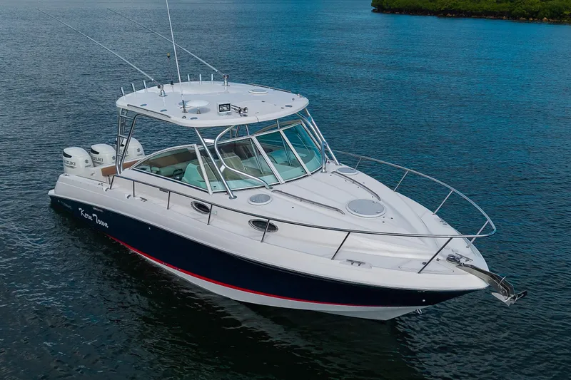  Yacht Photos Pics 2013 Wellcraft 340 Coastal boat on calm water, featuring sleek design and dual engines.