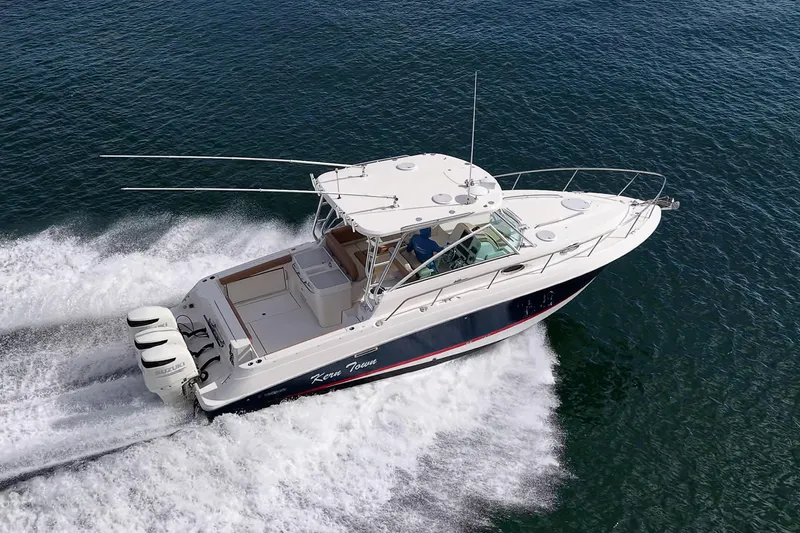  Yacht Photos Pics 2013 Wellcraft 340 Coastal boat cruising on open water, aerial view.