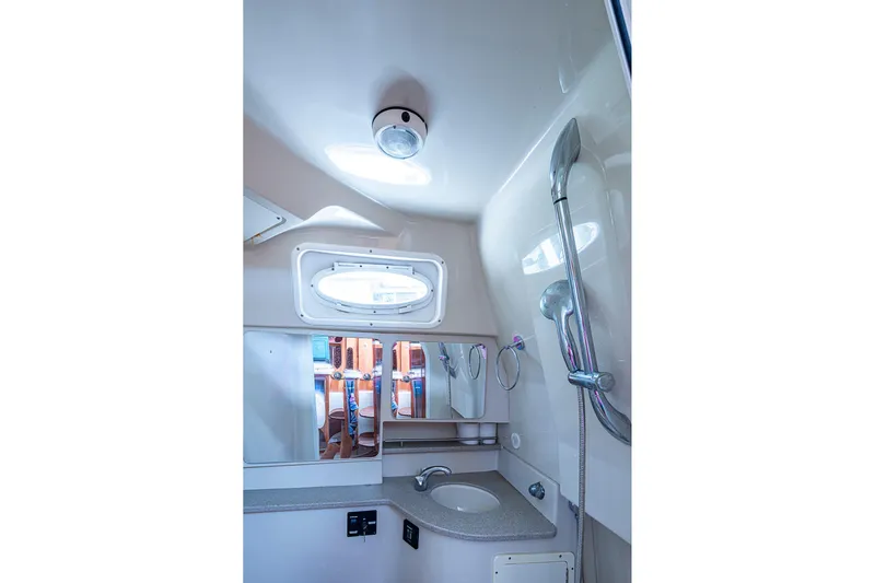  Yacht Photos Pics 2013 Wellcraft 340 Coastal bathroom with shower, sink, and mirror.