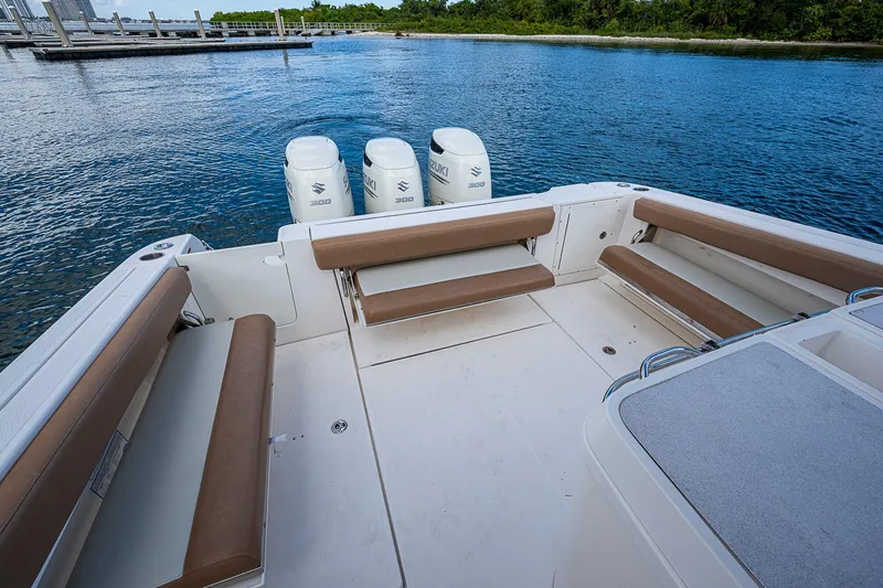  Yacht Photos Pics 2013 Wellcraft 340 Coastal boat with Suzuki engines, spacious seating, and scenic water view.