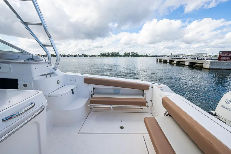  Yacht Photos Pics 2013 Wellcraft 340 Coastal boat interior with seating, overlooking a scenic waterfront.