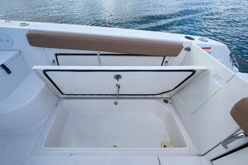  Yacht Photos Pics 2013 Wellcraft 340 Coastal boat storage compartment open, showcasing spacious interior.