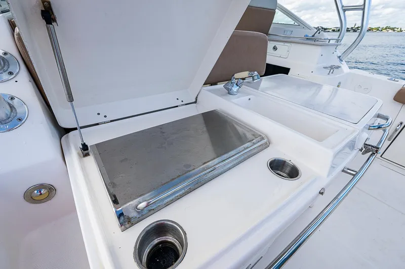 Yacht Photos Pics 2013 Wellcraft 340 Coastal boat interior with open storage compartment and stainless steel fixtures.