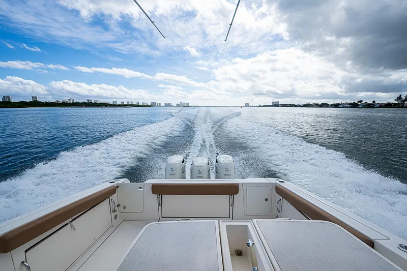  Yacht Photos Pics 2013 Wellcraft 340 Coastal boat cruising on open water, leaving a wake behind.