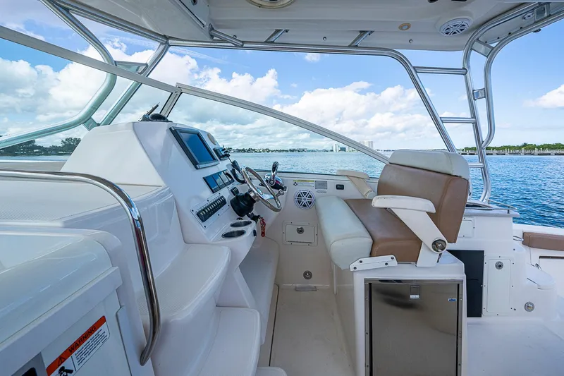  Yacht Photos Pics 2013 Wellcraft 340 Coastal boat interior with helm, seating, and ocean view.