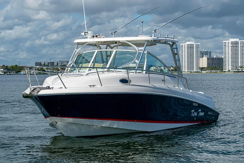  Yacht Photos Pics 2013 Wellcraft 340 Coastal boat on water with city skyline background.