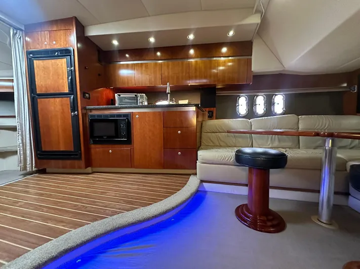 Cinta Yacht Photos Pics 2007 Cruisers Yachts 420 Express interior with kitchen, seating, and ambient lighting.