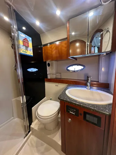 Cinta Yacht Photos Pics Luxurious 2007 Cruisers Yachts 420 Express bathroom with modern fixtures and wood cabinetry.