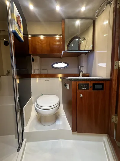 Cinta Yacht Photos Pics Luxurious 2007 Cruisers Yachts 420 Express bathroom with wood cabinetry and modern fixtures.