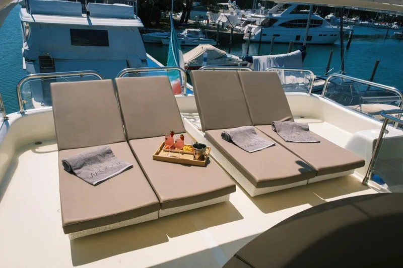  Yacht Photos Pics Sun loungers on 2004 Astondoa 82 GLX yacht deck with towels and drinks.