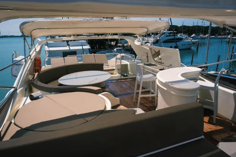  Yacht Photos Pics Luxurious 2004 Astondoa 82 GLX yacht deck with seating and bar area, docked at marina.