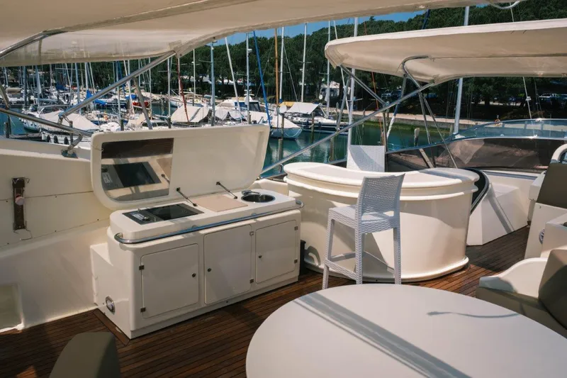  Yacht Photos Pics Luxurious 2004 Astondoa 82 GLX yacht deck with outdoor kitchen and seating area.