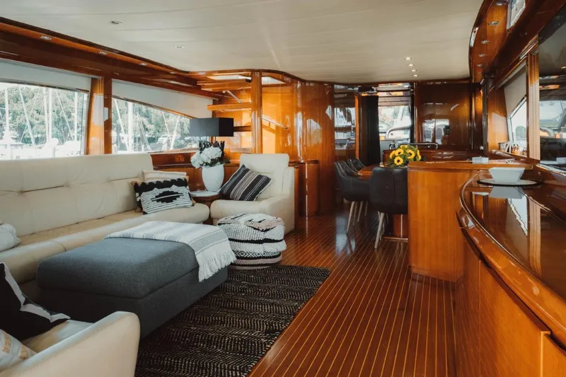  Yacht Photos Pics Luxurious interior of 2004 Astondoa 82 GLX yacht with elegant wood finishes and plush seating.