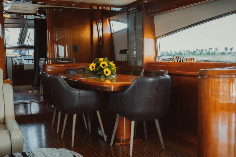  Yacht Photos Pics Luxurious interior of 2004 Astondoa 82 GLX yacht with elegant dining area and sunflowers.