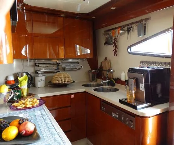  Yacht Photos Pics Luxurious kitchen interior of 2004 Astondoa 82 GLX yacht with modern appliances and fruit display.