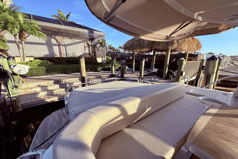 Tom's Cruise Yacht Photos Pics Luxury 2016 Cranchi M 44 HT yacht docked near tropical waterfront.