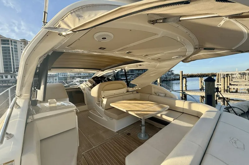 Tom's Cruise Yacht Photos Pics Luxurious 2016 Cranchi M 44 HT yacht interior with elegant seating and table, docked at marina.