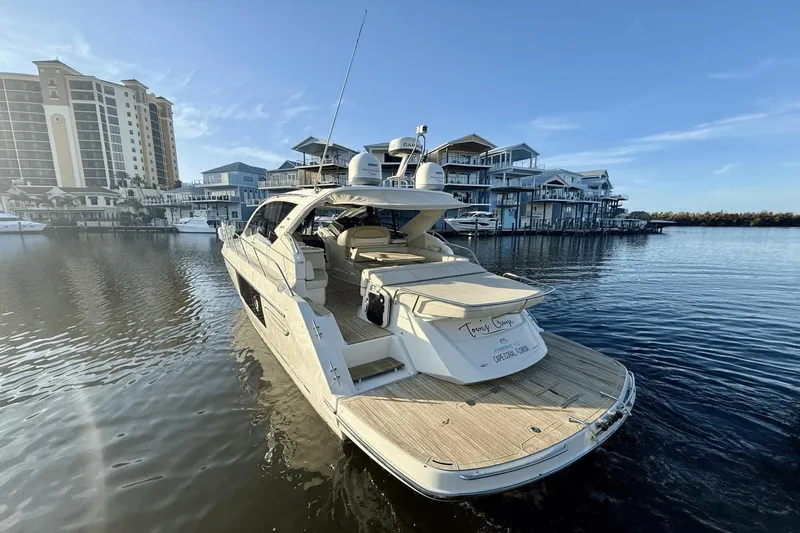 Tom's Cruise Yacht Photos Pics 2016 Cranchi M 44 HT yacht docked in a marina with waterfront buildings.