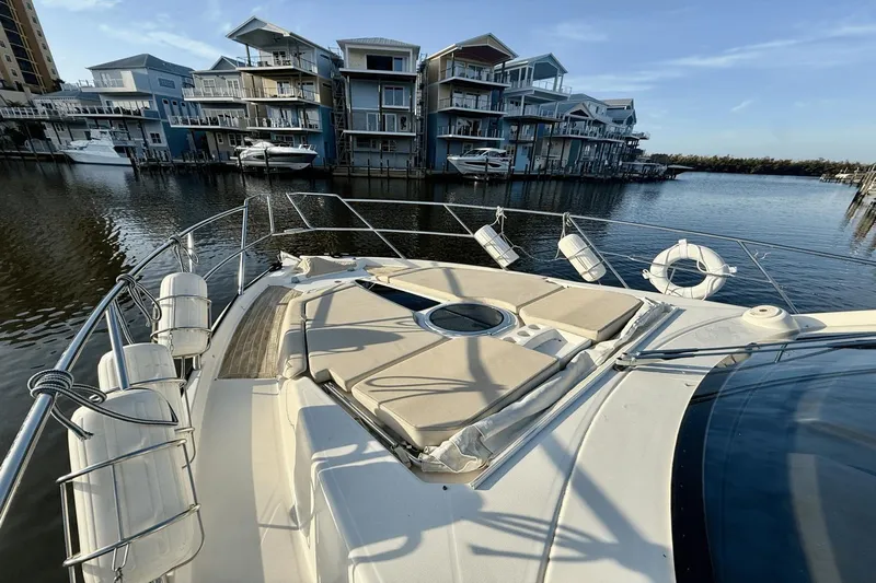 Tom's Cruise Yacht Photos Pics 2016 Cranchi M 44 HT yacht docked near modern waterfront homes.