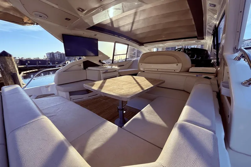 Tom's Cruise Yacht Photos Pics Luxurious interior of 2016 Cranchi M 44 HT yacht with seating and table.