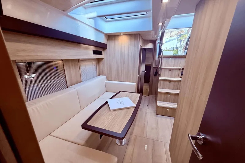 Tom's Cruise Yacht Photos Pics Luxurious interior of 2016 Cranchi M 44 HT yacht with modern seating and wooden finishes.