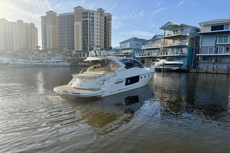Tom's Cruise Yacht Photos Pics 2016 Cranchi M 44 HT yacht docked near waterfront buildings.