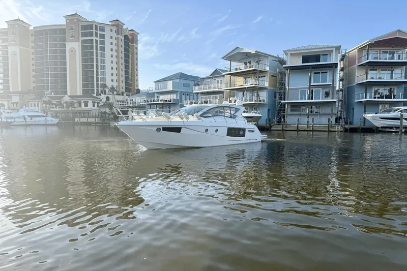 Tom's Cruise Yacht Photos Pics 2016 Cranchi M 44 HT yacht docked near modern waterfront buildings.