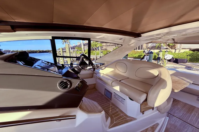 Tom's Cruise Yacht Photos Pics Interior of 2016 Cranchi M 44 HT yacht with beige seating and steering area.