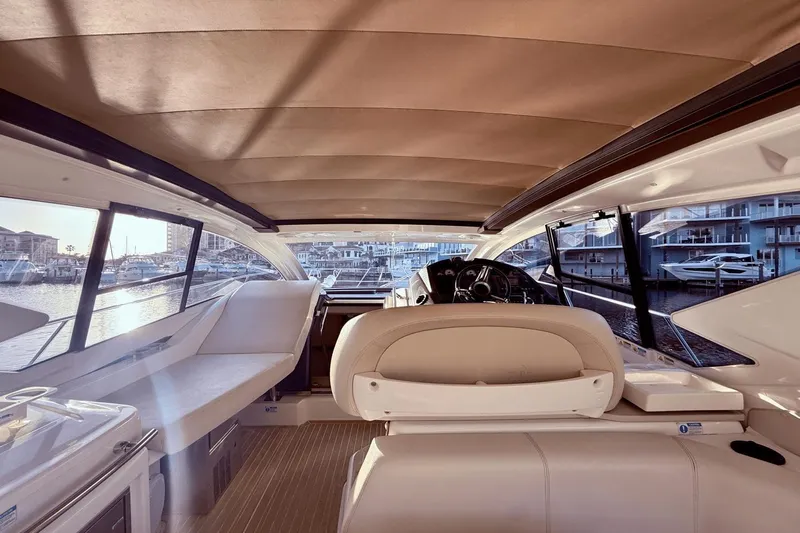 Tom's Cruise Yacht Photos Pics Interior view of 2016 Cranchi M 44 HT yacht, featuring luxurious seating and helm.