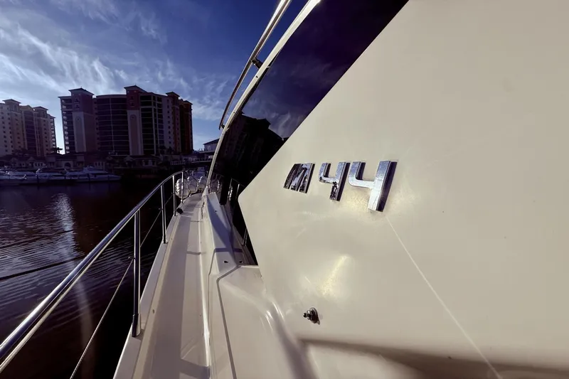 Tom's Cruise Yacht Photos Pics 2016 Cranchi M 44 HT yacht docked near waterfront buildings under a clear sky.