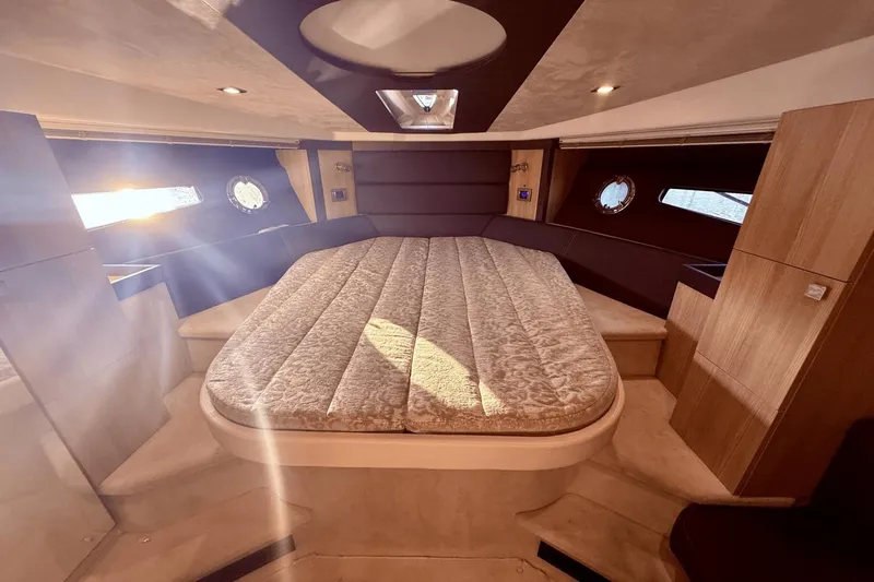 Tom's Cruise Yacht Photos Pics Luxurious 2016 Cranchi M 44 HT yacht cabin with elegant bedding and natural light.