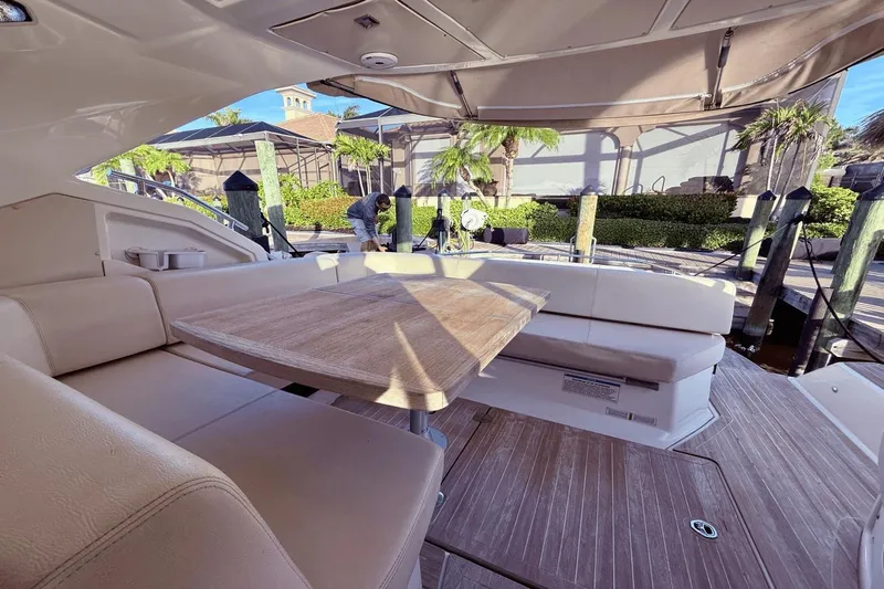 Tom's Cruise Yacht Photos Pics Luxurious 2016 Cranchi M 44 HT yacht interior with elegant seating and wooden table.