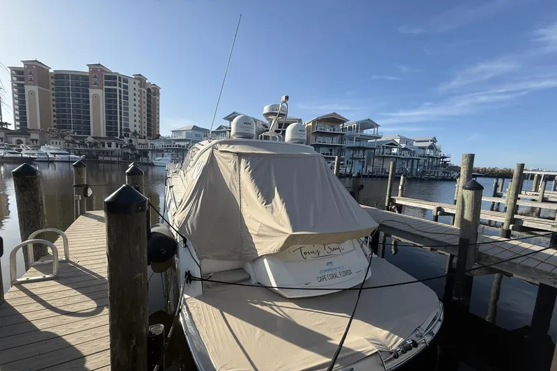 Tom's Cruise Yacht Photos Pics 2016 Cranchi M 44 HT yacht docked at marina with waterfront buildings.