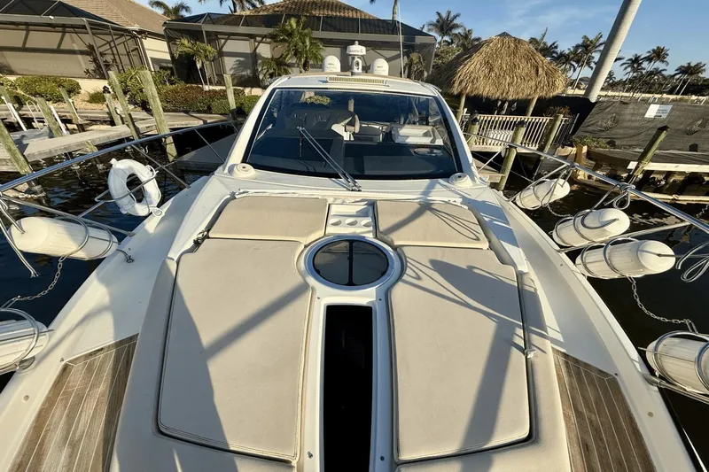 Tom's Cruise Yacht Photos Pics 2016 Cranchi M 44 HT yacht docked, featuring sleek design and sunbathing area.