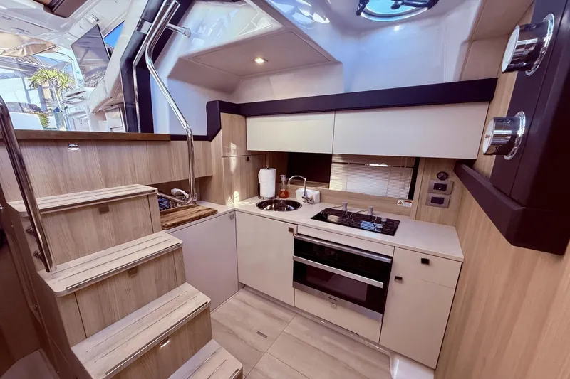 Tom's Cruise Yacht Photos Pics Modern kitchen interior of 2016 Cranchi M 44 HT yacht with sleek design and appliances.