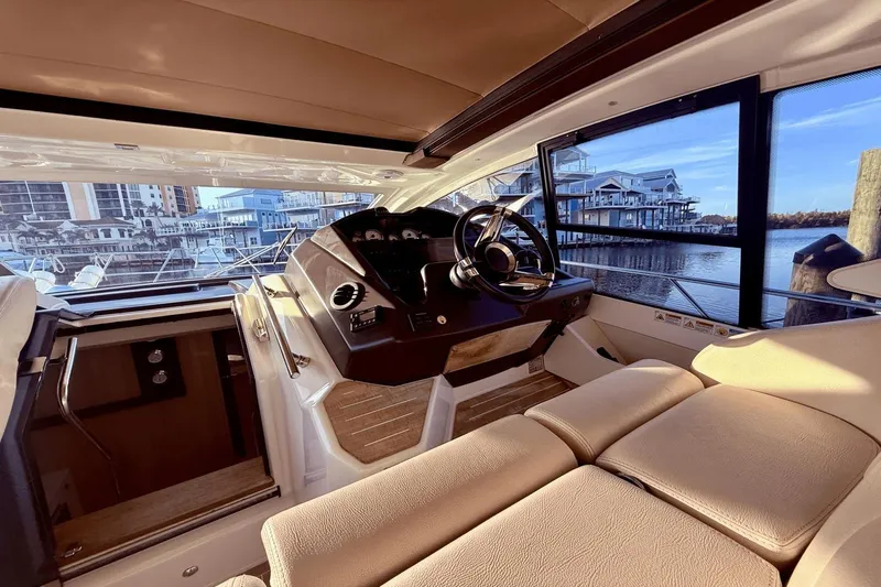 Tom's Cruise Yacht Photos Pics Interior of 2016 Cranchi M 44 HT yacht with luxurious helm and waterfront view.