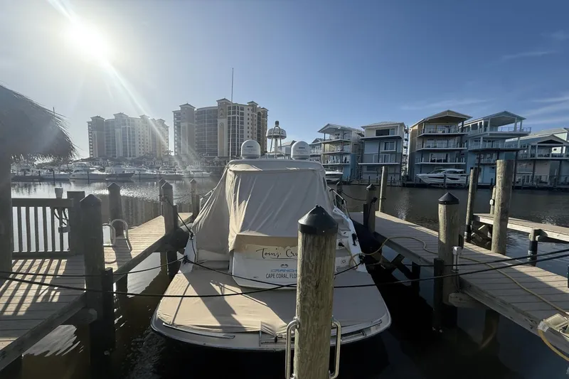 Tom's Cruise Yacht Photos Pics 2016 Cranchi M 44 HT yacht docked at marina, surrounded by waterfront buildings.