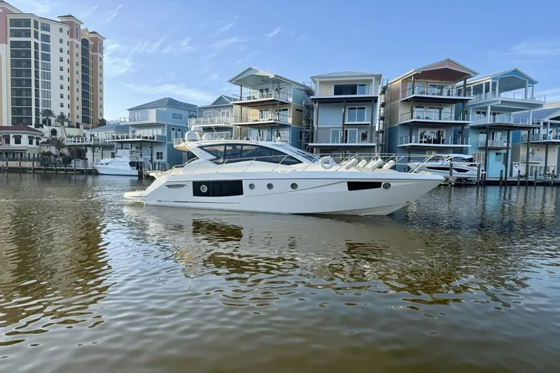 Tom's Cruise Yacht Photos Pics 2016 Cranchi M 44 HT yacht docked near modern waterfront buildings.