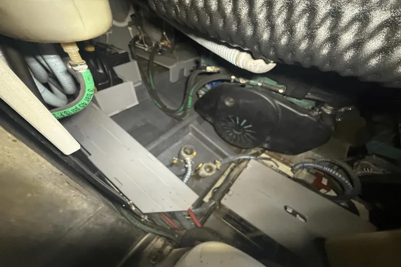 Tom's Cruise Yacht Photos Pics Engine compartment of a 2016 Cranchi M 44 HT yacht, showcasing hoses and mechanical components.