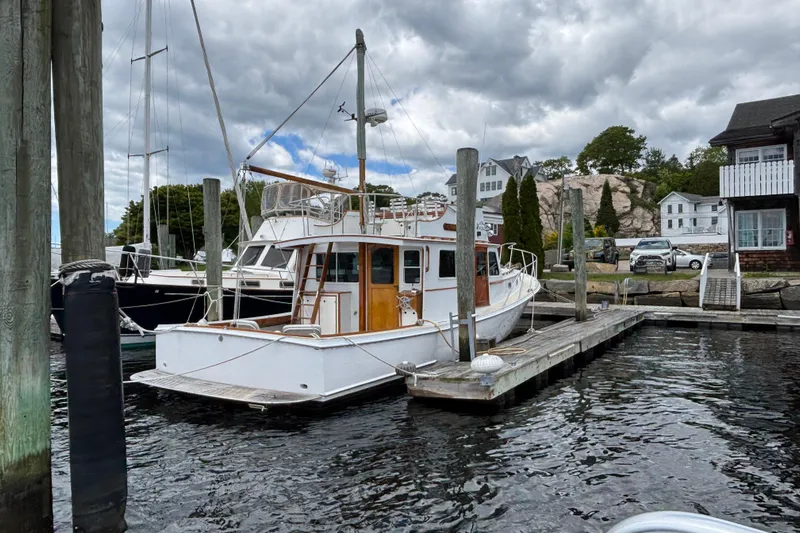 Carroll L Yacht Photos Pics Lowell 40 boat docked at marina, cloudy sky, waterfront houses in background, 2001 model.