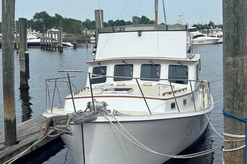 Carroll L Yacht Photos Pics 2001 Lowell 40 boat docked at marina, surrounded by water and other vessels.