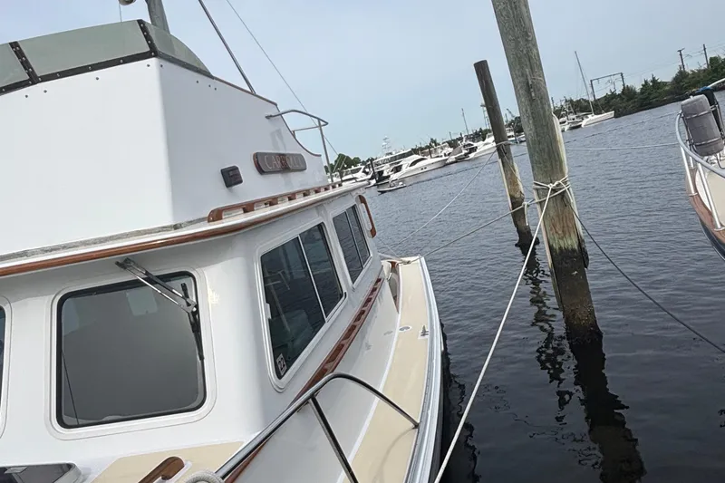 Carroll L Yacht Photos Pics Boat docked at marina, Lowell 40 model, 2001, with calm water and other boats in background.
