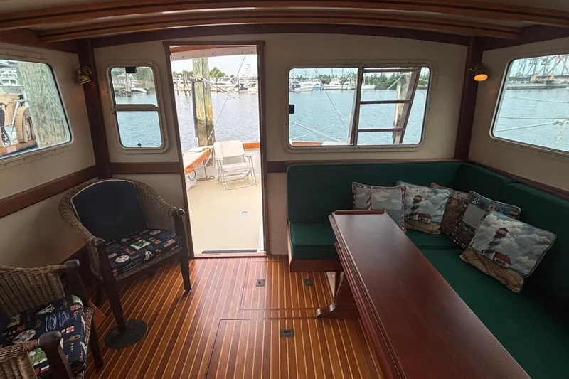 Carroll L Yacht Photos Pics Interior of a 2001 Lowell 40 boat with wooden flooring and nautical-themed decor.