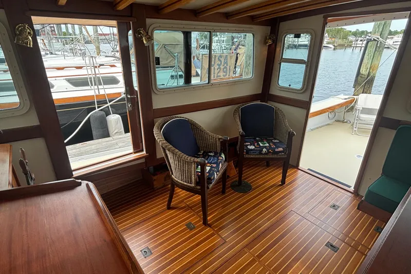 Carroll L Yacht Photos Pics Interior of 2001 Lowell 40 boat with wooden flooring and wicker chairs.