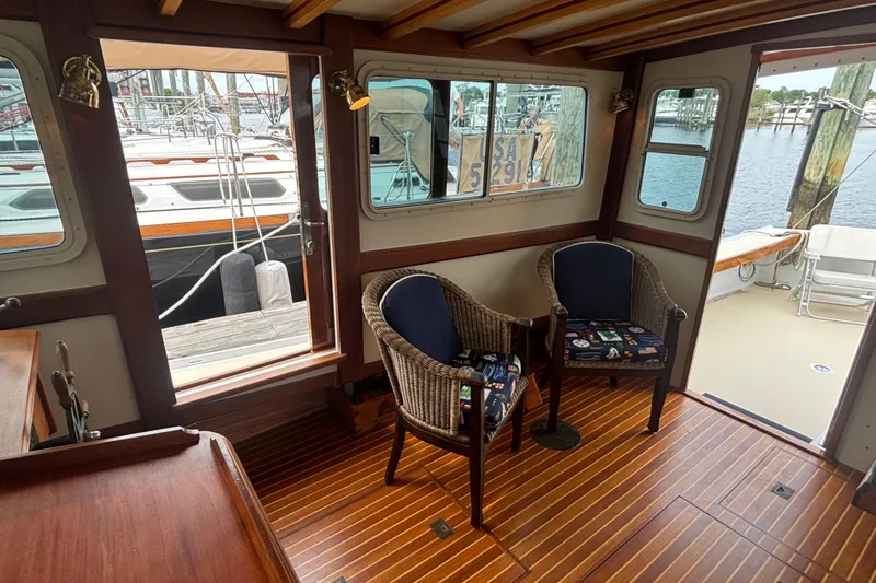 Carroll L Yacht Photos Pics Interior of 2001 Lowell 40 boat with wooden flooring and wicker chairs.