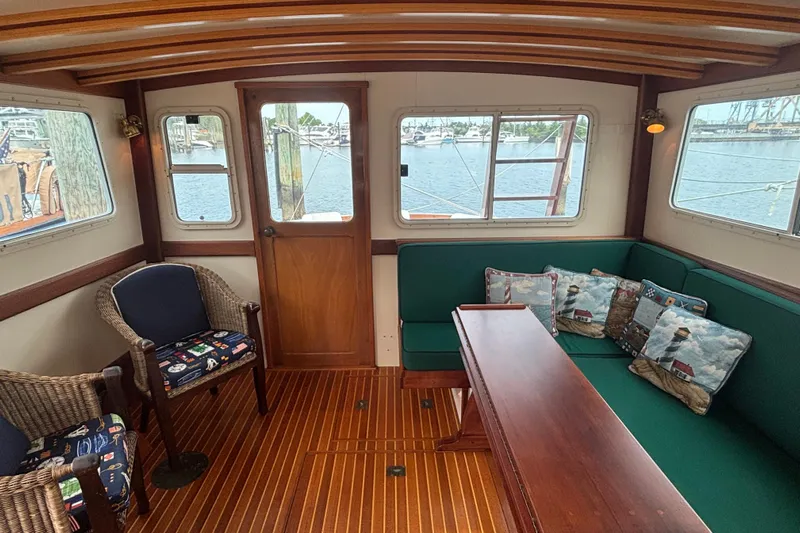 Carroll L Yacht Photos Pics Interior of a 2001 Lowell 40 boat with wooden furnishings and nautical-themed decor.