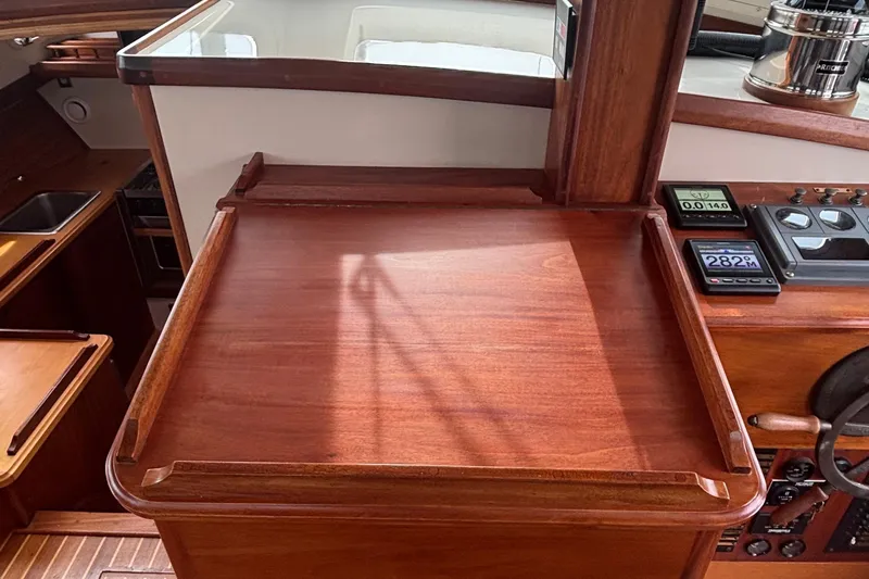 Carroll L Yacht Photos Pics Wooden navigation station on a 2001 Lowell 40 boat, featuring control panels and instruments.