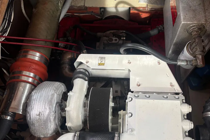Carroll L Yacht Photos Pics Engine compartment of a 2001 Lowell 40, featuring various mechanical components and hoses.